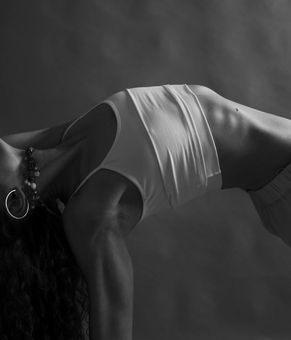 Woman in a graceful yoga pose focusing on pelvic area.